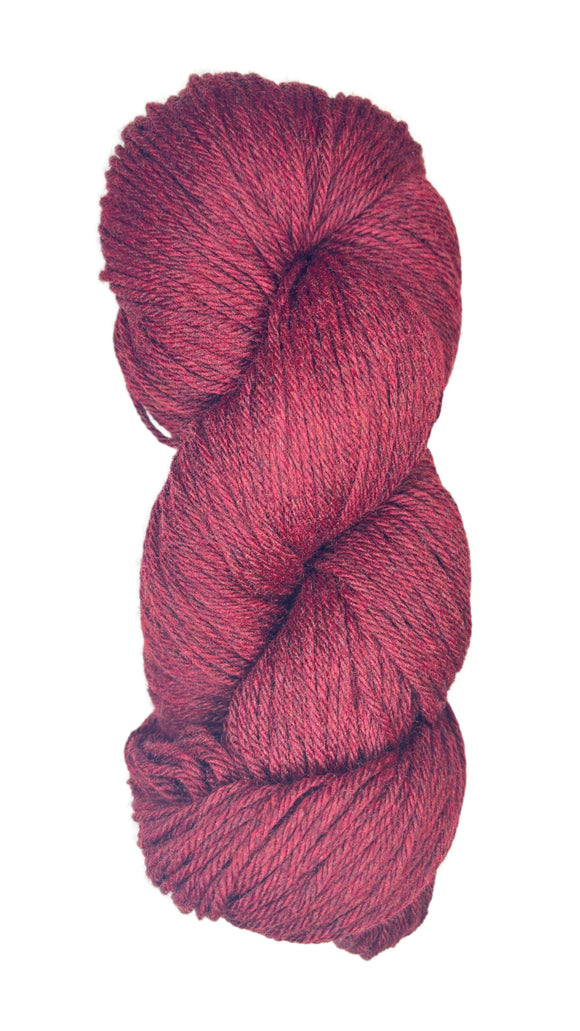 A skein of Berroco Vintage Worsted yarn color Cherry Red with Black marl
