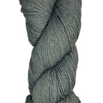 A skein of Berroco Vintage Wool Yarn in the color heathered grey with flecks of sage green and light khaki some navy
