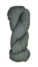 A skein of Berroco Vintage Wool Yarn in the color heathered grey with flecks of sage green and light khaki some navy
