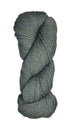 A skein of Berroco Vintage Wool Yarn in the color heathered grey with flecks of sage green and light khaki some navy