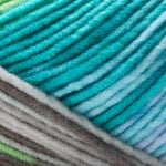 Detailed image of Universal Yarn Maman Acrylic Yarn in the colors blue grey white brown green