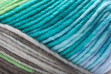 Detailed image of Universal Yarn Maman Acrylic Yarn in the colors blue grey white brown green
