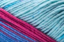 Detailed image of Universal Yarn Maman Acrylic Yarn in the colors blue red pink light blue