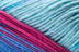 Detailed image of Universal Yarn Maman Acrylic Yarn in the colors blue red pink light blue