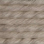 A close-up texture shot of thick, twisted cotton cord or rope in a warm off-white or cream color, stacked horizontally.