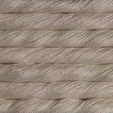 A close-up texture shot of thick, twisted cotton cord or rope in a warm off-white or cream color, stacked horizontally.
