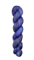 A skein of hand-dyed fingering/sock yarn color grey blue purple speckles