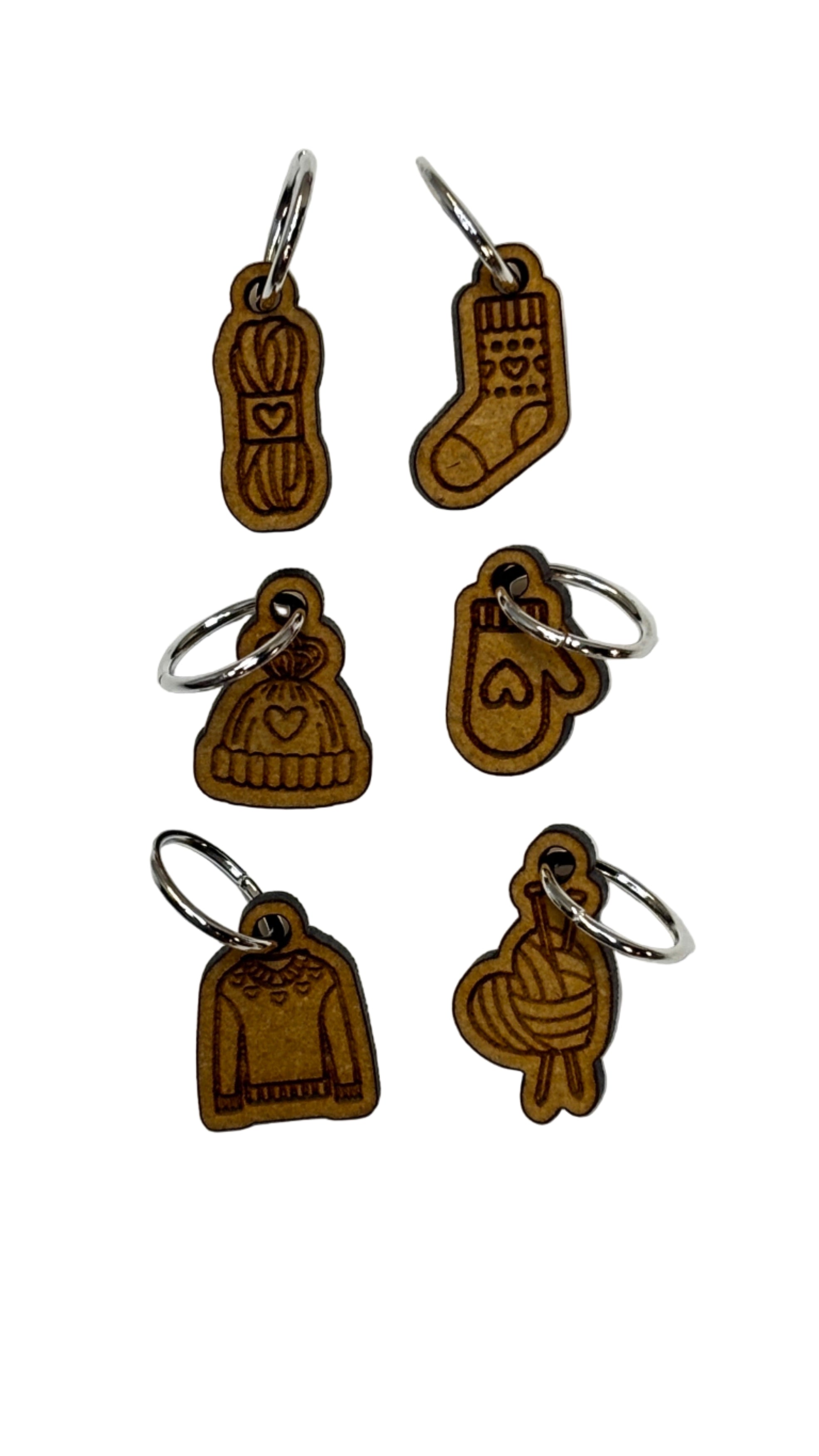 Wooden stitch markers with engraved detail of a sock, hat, mitten, yarn and a sweater