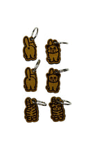 Wooden stitch markers with engraved detail of a cat facing front and back