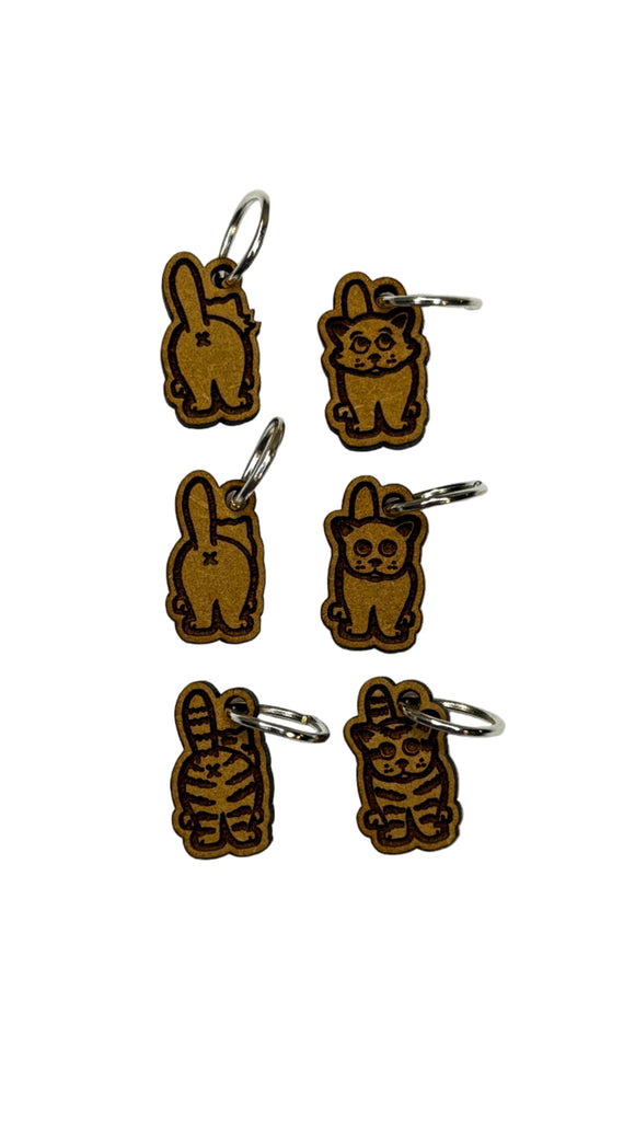 Wooden stitch markers with engraved detail of a cat facing front and back