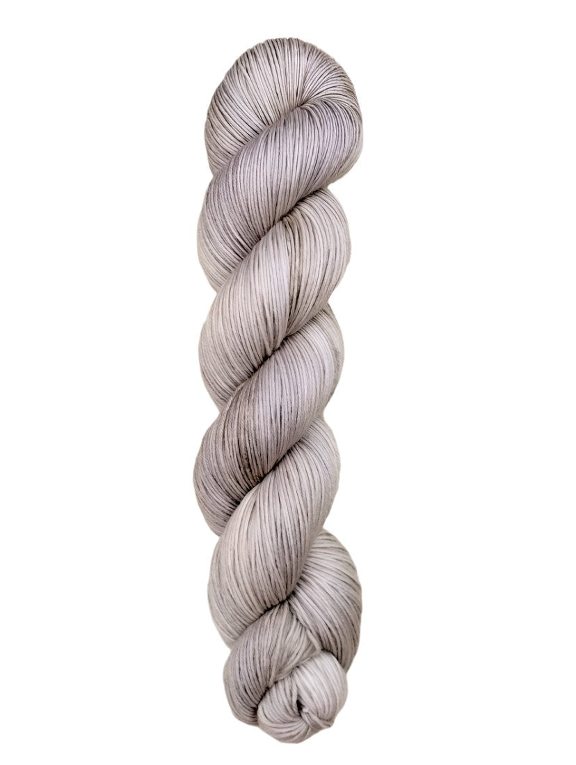 A skein of hand-dyed fingering/sock yarn color grey white 