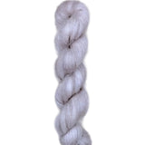 Skein of superkid mohair silk lace weight yarn color grey white