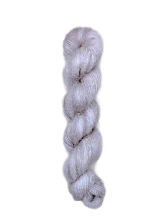 Skein of superkid mohair silk lace weight yarn color grey white