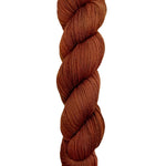 A skein of hand-dyed fingering/sock yarn color auburn burnt orange