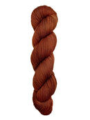 A skein of hand-dyed fingering/sock yarn color auburn burnt orange