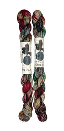 Two mini skeins of wool yarn hand dyed in Wyoming in the color brown red green black