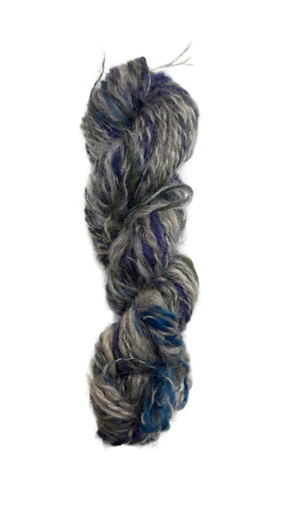Multicolored skein of handspun yarn in the colors grey blue green 