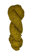 Ball of mustard yellow wool yarn on a white background
