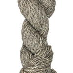 Coiled skein of gray wool yarn on a white background