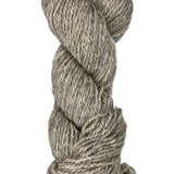 Coiled skein of gray wool yarn on a white background