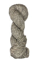 Coiled skein of gray wool yarn on a white background