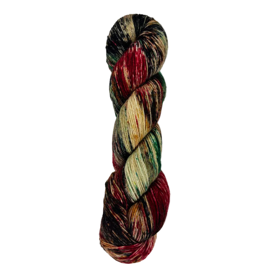 A skein of hand-dyed fingering/sock yarn color brown black red green speckles