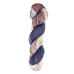 A skein of hand-dyed fingering/sock yarn color mauve white grey black speckles