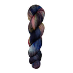 A skein of hand-dyed fingering/sock yarn color pink grey navy brown black 