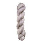 A skein of hand-dyed fingering/sock yarn color grey white 