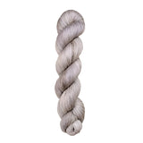 A skein of hand-dyed fingering/sock yarn color grey white 