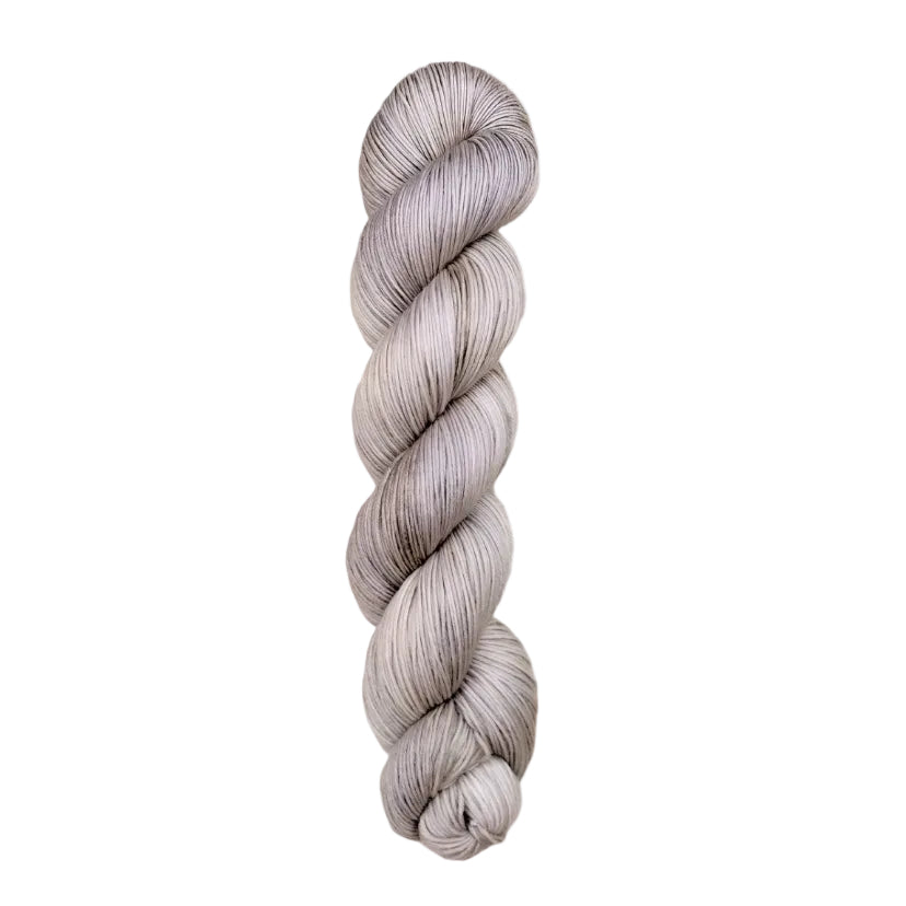 A skein of hand-dyed fingering/sock yarn color grey white 