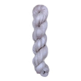 Skein of superkid mohair silk lace weight yarn color grey white