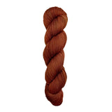 A skein of hand-dyed fingering/sock yarn color auburn burnt orange