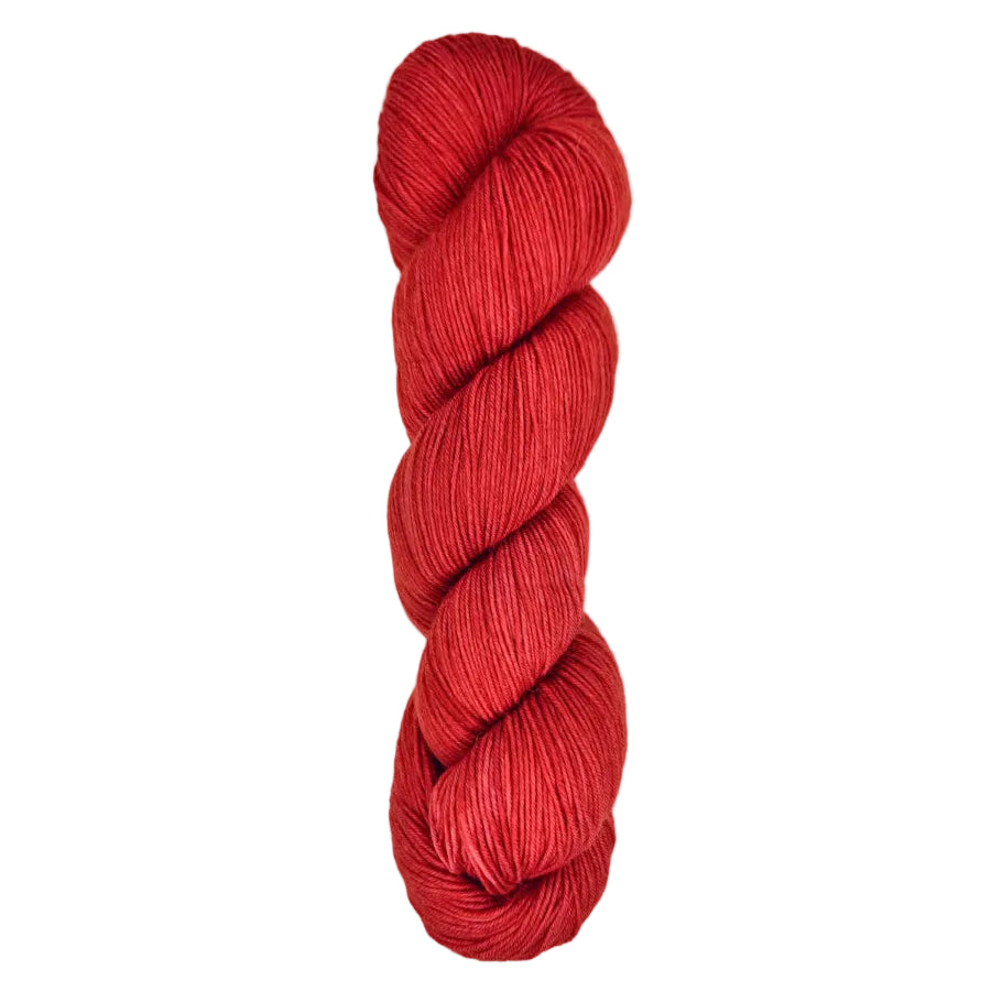 A skein of hand-dyed fingering/sock yarn color red