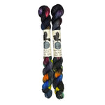 Two mini skeins of wool yarn hand dyed in Wyoming in the color black red orange yellow blue green