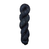 Dark black skein of yarn with white specks on a white background