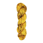 A skein of hand-dyed fingering/sock yarn color yellow brown speckles