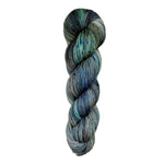 Dark blue and green skein of yarn on a white background