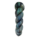 Dark blue and green skein of yarn on a white background