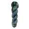 Dark blue and green skein of yarn on a white background