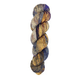 A skein of hand-dyed fingering/sock yarn color grey tan brown navy black speckles