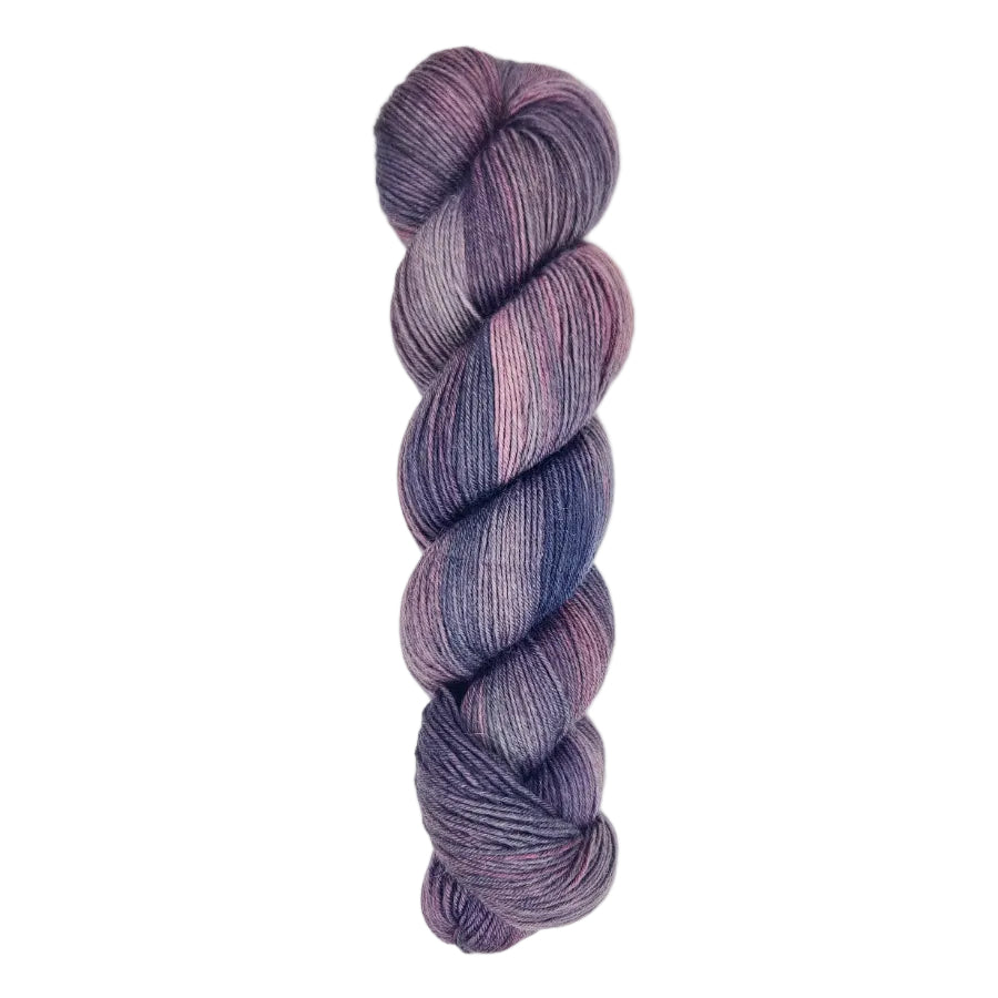 A skein of hand-dyed fingering/sock yarn color purple blue pink