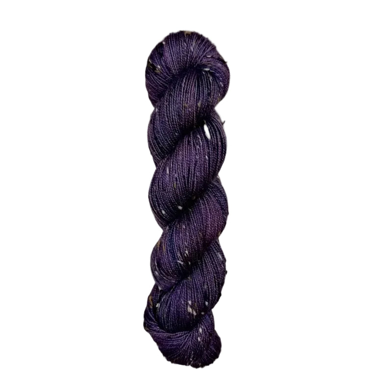 Skein of hand dyed BFL Tweed Yarn color deep purple