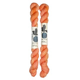 Two mini skeins of wool yarn hand dyed in Wyoming in the color coral