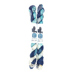 Blackbird Sycamore Fingering Mini Skein color variegated dark blue with streaks of light blue and white, and flecks of yellow and black