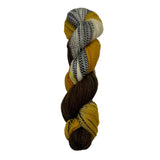 brown, gold, and black striped skein of yarn