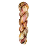 A skein of hand-dyed fingering/sock yarn color orange red white brown speckles