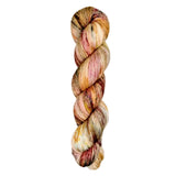 A skein of hand-dyed fingering/sock yarn color orange red white brown speckles