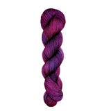 Purple skein of yarn on a white background