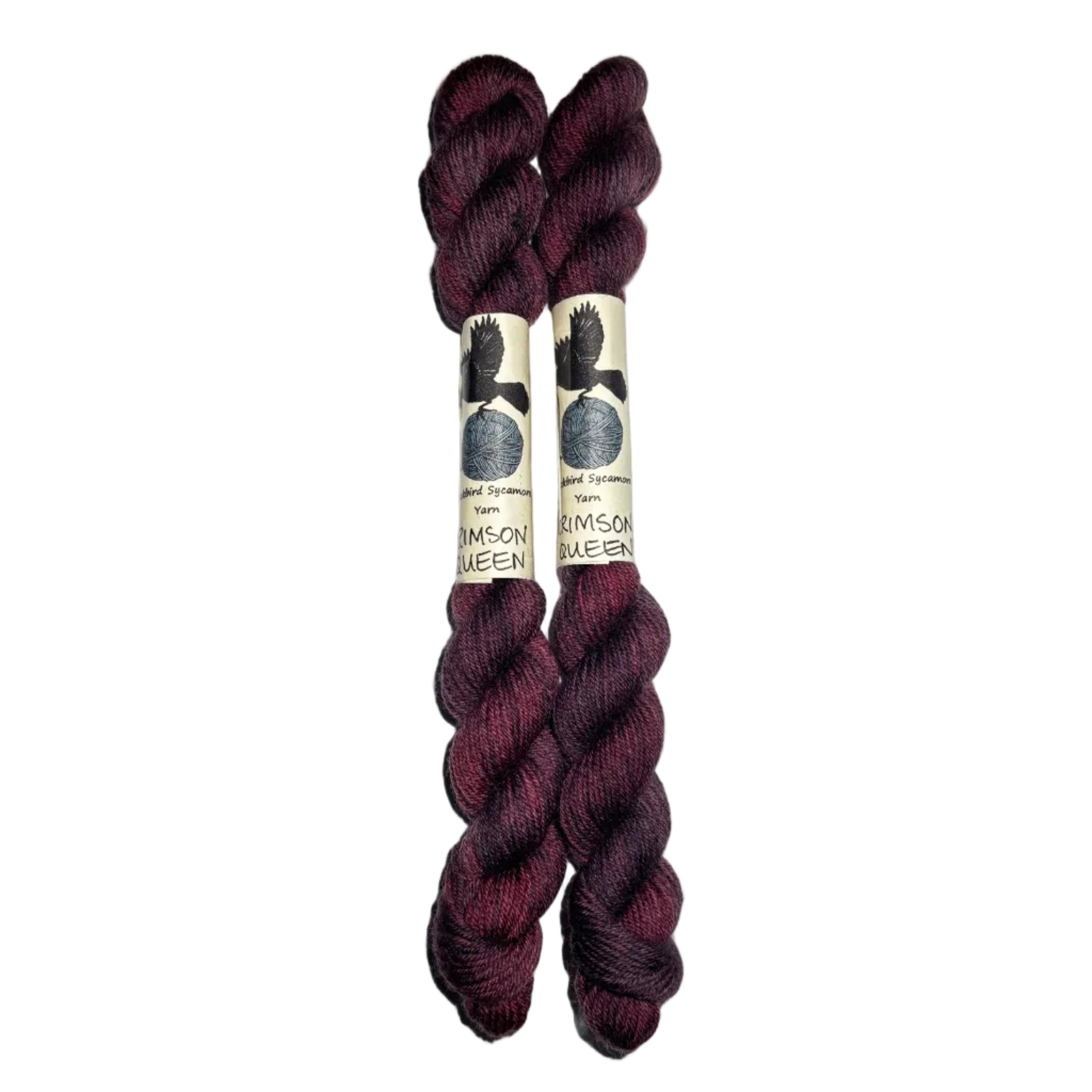 two mini skeins of yarn in a dark wine color